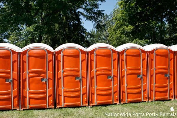 a lineup of clean and well-maintained portable loos for workers in Mount Vernon, AL